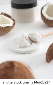 Scrub In Wood Spoon With Jar Coconut On White Background. Home Spa Treatment Concept, Organic Cosmetic. Vertical Photo