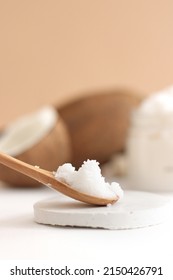 Scrub In Wood Spoon With Jar Coconut On White And Brown Background. Home Spa Treatment Concept, Organic Cosmetic. Vertical Photo