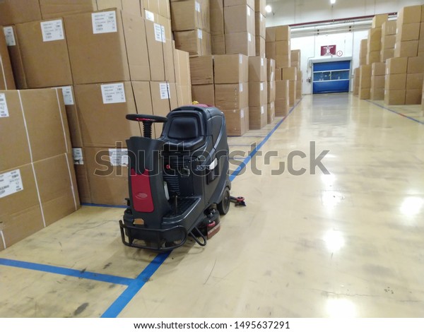 Scrubber drier for cleaning storage\
facilities.  Close-up.Floor polisher.Floor cleaning machine. Floor\
maintenance.