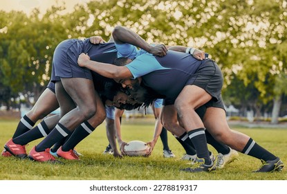 Scrum, sports and men playing rugby, catching a ball and preparing for a game on the field. Ready, together and competitive players scrumming for the start of a sport competition with contact - Shutterstock ID 2278819317