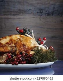 Scrumptious Roast Turkey Chicken On Platter With Festive Decorations For Thanksgiving Or Christmas Lunch, Against Dark Recycled Wood Background. Vertical With Copy Space.