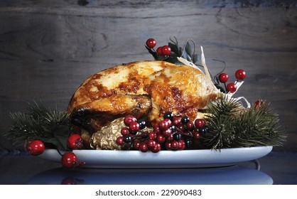 Scrumptious Roast Turkey Chicken On Platter With Festive Decorations For Thanksgiving Or Christmas Lunch, Against Dark Recycled Wood Background.
