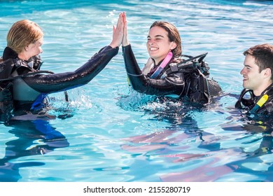 Scuba Dive Training In The Pool With The Instructor Giving A High Five To The Happy Student