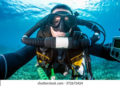 SCUBA diver with a closed circuit rebreather on a tropical coral reef