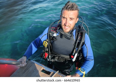 Scuba Diver Coming Out From The Water