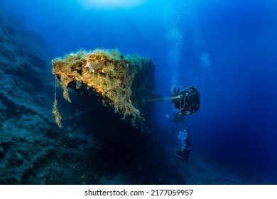 A scuba diver explores an old, sunken shipwreck in the Aegean Sea, Kea island, Greece 