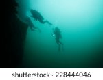 Scuba diver exploring world war II shipwreck in Coron area, Palawan, Philippines.