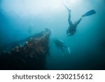 Scuba diver exploring world war II shipwreck in Coron area, Palawan, Philippines.
