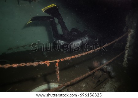 Scuba diver exploring a wreck ship in the ocean. Picture taken in the former Canadian Navy Destroyer HMCS Annapolis that was sunken in Howe Sound, near Vancouver, British Columbia, Canada.