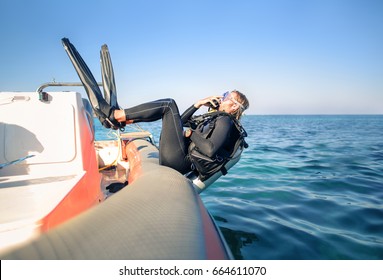 Scuba Diver Jumping In The Water From A Boat