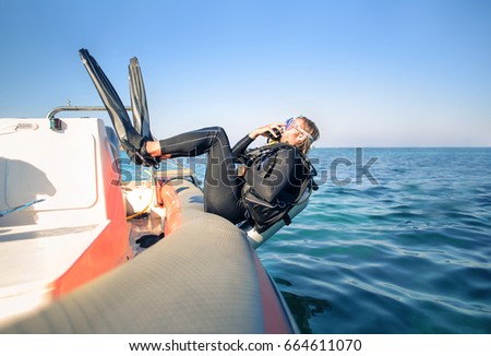 Scuba diver jumping in the water from a boat