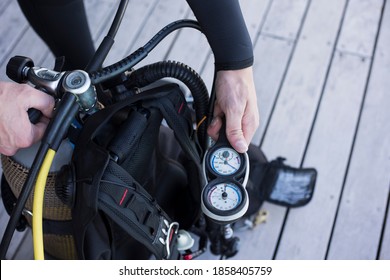 Scuba Diver Kitting Up And Checking The Pressure Gauge, Close Up Of Hand Holding Equipment.