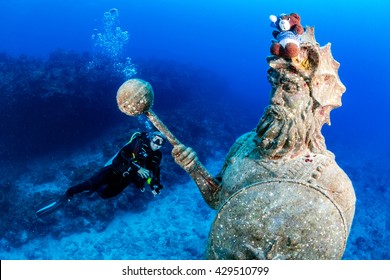 SCUBA diver and a large underwater statue - Powered by Shutterstock