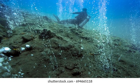 Scuba Diver Relaxing In Hot Water Bubbles At Underwater Volcano, Pulau Weh