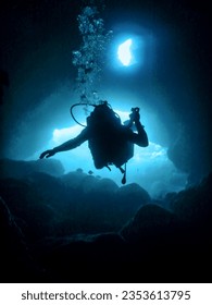 Scuba Diver Silhouette in Underwater Cave