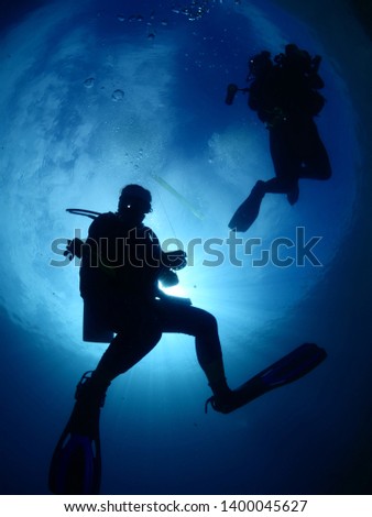 Similar – Two persons in their back with scuba diving equipment exploring the ocean floor.