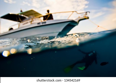 Scuba Diver Swims Under A Boat