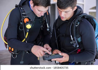 Scuba Divers Kitting Up And Checking Their Gear, Interacting Talking About The Pressure Gauge