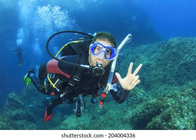 Scuba Diving Instructor Leads A Group Of Divers