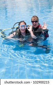 Scuba Diving Instructor And Student Having Fun  In A Swimming Pool