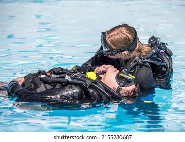 Scuba Diving rescue course surface skills checking for breathing of an unconscious diver - Shutterstock ID 2155280687