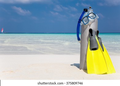 Scuba Diving Tank, Fins And Mask On A Beach