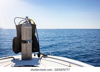 A Scuba Diving Tank And Gear Standing On A Boat Bow With Blue Sea And Sunshine