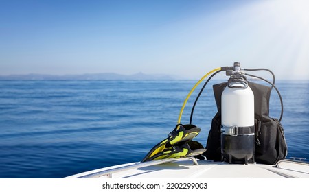 A Scuba Diving Tank And Gear Standing On A Boat Bow With Blue Sea And Sunshine As A Banner With Copy Space