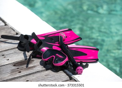 Scuba Mask With Pink Flippers On Wooden Pier Background