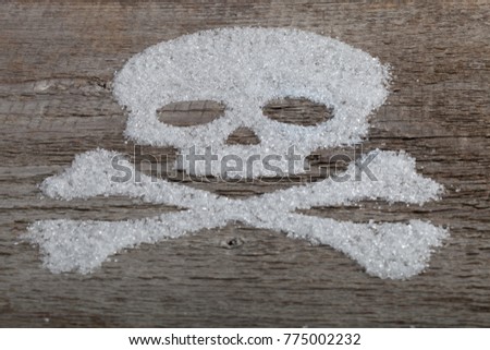 Scull  with crossbones made from different substanc?  on old the wood table. selective focus