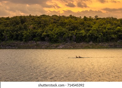 Sculling under sunset sky - Powered by Shutterstock