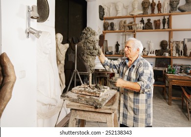 Sculptor Creates Head In A Studio