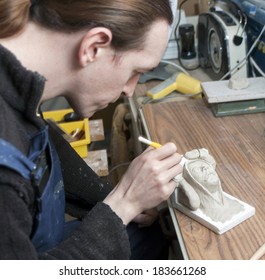 Sculptor Modeling clay models in workshop.