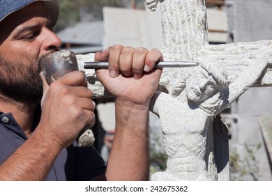 Sculptor Working On A Jesus Stone Sculpture.