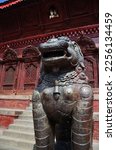 Sculpture ancient bronze napali lion singha guardian statues and carving wooden building Shiva Parvati hindu temple for people travelers visit at Basantapur Katmandu durbar square in Kathmandu, Nepal