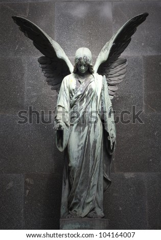 sculpture of an angel with  dark background