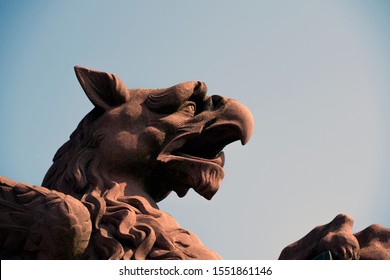 Sculpture: Brown Griffin Head Against The Sky
