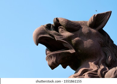 Sculpture: Brown Griffin Head Against The Sky
