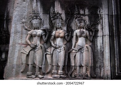 Sculpture carving figure apsaras or apsara angel deity female spirit of clouds and waters elegant and superb art of dancing in Hindu and Buddhist culture on wall of Angkor wat at Siem Reap, Cambodia