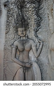 Sculpture carving figure apsaras or apsara angel deity female spirit of clouds and waters elegant and superb art of dancing in Hindu and Buddhist culture on wall of Angkor wat at Siem Reap, Cambodia
