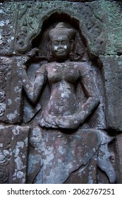 Sculpture carving figure apsaras or apsara angel deity female spirit of clouds waters and superb art of dancing in Prasat Ta Prohm or Ancestor Brahma temple of Angkor Thom Wat in Siem Reap, Cambodia