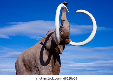 Sculpture Of Extinct Wooly Mammoth In Aggressive Pose.