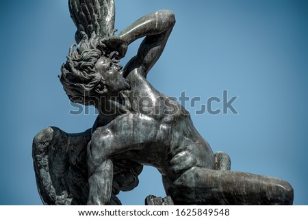 The sculpture of the fallen angel in madrid's retiro park