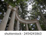 A sculpture in the form of a Greek theatre provides a window through the trees over Lake Maitland in Winter Park, Florida.