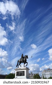 Sculpture Of A King Riding On Horse And A Bird Flying In Front Of It. Under The Wonderful Blue Sky Full Of Strange Clouds In Paris.