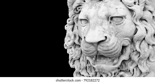 Sculpture of a medieval lion head of stone (Italy) - Image with copy space isolated on black background for easy selection