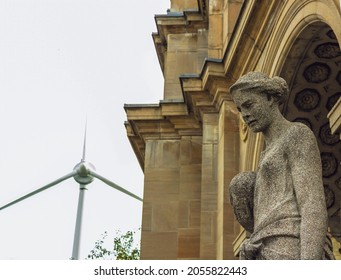 The Sculpture Of Minerva At The Ontario Government Building With A Windmill In The Background.