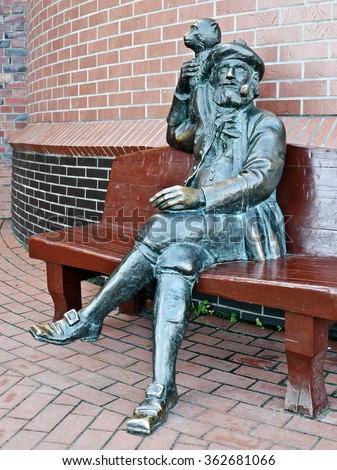 Sculpture of the old skipper with a monkey on his shoulder. Fishing village, Kaliningrad, Russia