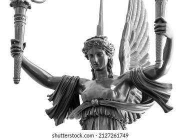 Sculpture of a Winged Victory goddess Nika. Statue of a beautiful holy angel with wings holding a torchs isolated at white background with clipping path