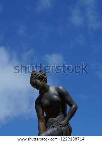 Sculpture of a woman against the sky